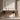 Stanley Furniture Horizon Mid-Century writing desk in warm wood finish styled in a neutral home office with floral wall art, vases, and books creating a clean minimalist workspace vignette.